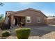 Backyard features a covered patio, gravel, and well-maintained landscaping at 16468 W Mariposa Grande --, Surprise, AZ 85387