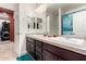 Bathroom with double vanity, shower, and adjacent laundry at 16468 W Mariposa Grande --, Surprise, AZ 85387