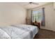 Bedroom with a bed, nightstand, and window at 16468 W Mariposa Grande --, Surprise, AZ 85387