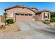 Single-story home with two-car garage and neatly landscaped front yard at 16468 W Mariposa Grande --, Surprise, AZ 85387