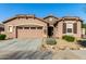 Single-story home with two-car garage, landscaping, and desert-inspired exterior at 16468 W Mariposa Grande --, Surprise, AZ 85387
