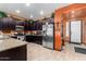 Dark wood cabinetry, granite countertops, and stainless steel appliances at 16468 W Mariposa Grande --, Surprise, AZ 85387