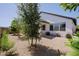 Private backyard oasis with gravel landscaping and mature trees at 17221 W Middlebury St, Surprise, AZ 85388