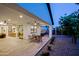 Covered patio with a ceiling fan, outdoor seating, and desert landscaping at 17221 W Middlebury St, Surprise, AZ 85388
