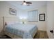 Bright bedroom with a queen-size bed and wood-look flooring at 17221 W Middlebury St, Surprise, AZ 85388
