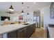 Modern kitchen with island, stainless steel appliances, and white countertops at 17221 W Middlebury St, Surprise, AZ 85388