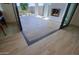 View of backyard patio with stone tile flooring and fireplace at 17221 W Middlebury St, Surprise, AZ 85388