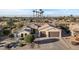 Single-story home with tile roof and a two-car garage, in a golf community at 20064 N Rawhide Way, Surprise, AZ 85387