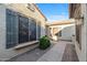 Inviting courtyard entry with lush landscaping and a stone pathway at 20064 N Rawhide Way, Surprise, AZ 85387