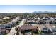 Aerial view of a large house with a pool in a residential neighborhood with mountain views at 21774 E Camacho Rd, Queen Creek, AZ 85142