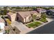 Single-story home with a three-car garage and manicured lawn at 21774 E Camacho Rd, Queen Creek, AZ 85142