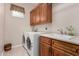 Laundry room with washer, dryer, and cabinets at 21774 E Camacho Rd, Queen Creek, AZ 85142