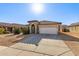 Single story home with a two-car garage and well-maintained yard at 25781 W Nancy Ln, Buckeye, AZ 85326