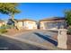 Two-car garage, light-colored stucco, and mature tree at 2737 N 160Th Ave, Goodyear, AZ 85395