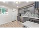 Modern gray kitchen with white quartz countertops at 3002 W Griswold Rd, Phoenix, AZ 85051