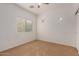 Well-lit bedroom with window and ceiling fan at 4234 E Washington Ct, Gilbert, AZ 85234