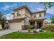 Two-story house with beige exterior, stone accents, and a two-car garage at 4234 E Washington Ct, Gilbert, AZ 85234