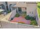 Private patio with brick pavers, mature plants, and a block wall for added privacy at 4551 W Continental Dr, Glendale, AZ 85308