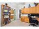 Spacious home office with wood cabinets, desk, and built-in bookshelves at 4662 W Fallen Leaf Ln, Glendale, AZ 85310