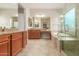 Modern bathroom with a walk-in shower, double vanity and granite countertop at 8102 W Autumn Vista Way, Florence, AZ 85132