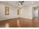 Bright bedroom featuring hardwood floors, plantation shutters and an ensuite bathroom at 8102 W Autumn Vista Way, Florence, AZ 85132