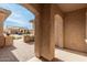 View through archway of a house, driveway, and another house in the background at 8102 W Autumn Vista Way, Florence, AZ 85132