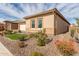 Tan house with two windows, landscaping, and a red real estate sign. Artificial turf in front at 8102 W Autumn Vista Way, Florence, AZ 85132