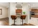 Kitchen island with seating and granite countertop at 8102 W Autumn Vista Way, Florence, AZ 85132