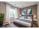 Cozy bedroom with a gray headboard, neutral decor, and natural light at 8712 W Sequoia Dr, Peoria, AZ 85382