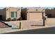 Tan stucco house with a two-car garage and a landscaped front yard at 9346 E Citrus N Ln, Sun Lakes, AZ 85248