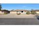 House exterior showcasing a single-story home with a two-car garage and desert landscaping at 9506 W Calico Dr, Sun City, AZ 85373