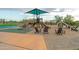 Community playground with shade structure and seating at 11696 E Charter Oak Dr, Scottsdale, AZ 85259