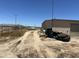 Large storage shed with tires and boat in front at 12601 S Hermit Rd, Buckeye, AZ 85326