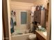 Bathroom with shower/tub combo, vanity, and linen storage at 12807 N 21St Dr, Phoenix, AZ 85029