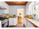 Kitchen with terracotta tile floors and white cabinets at 1329 W Lynwood St, Phoenix, AZ 85007