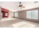 Open living area with vaulted ceiling, neutral colors, and ceiling fan at 14738 N 147Th Dr, Surprise, AZ 85379