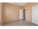 Bright bedroom with tile floors and access to hallway at 15224 W Pasadena Dr, Surprise, AZ 85374