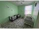 Charming bedroom with two cribs and a neutral color palette at 17713 W Post Dr, Surprise, AZ 85388