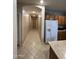 Long hallway with tile flooring and access to other rooms at 17713 W Post Dr, Surprise, AZ 85388