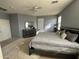 Main bedroom with large bed, dresser, and access to bathroom at 17713 W Post Dr, Surprise, AZ 85388