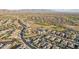 Aerial view showing houses, roads and a golf course in a community at 18215 W Desert Sage Dr, Goodyear, AZ 85338