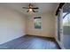 Well-lit bedroom featuring hardwood floors and access to a private patio at 18526 N 94Th St, Scottsdale, AZ 85255