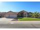 Beautiful single-story home with a three-car garage and lush lawn at 19418 N 86Th Dr, Peoria, AZ 85382