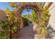 Wicker archway entry to a garden path at 3146 N 157Th Ln, Goodyear, AZ 85395