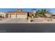 Two-car garage and driveway of tan house with desert landscaping at 3146 N 157Th Ln, Goodyear, AZ 85395