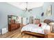 Main bedroom with light blue walls, wood floors, and a ceiling fan at 3146 N 157Th Ln, Goodyear, AZ 85395