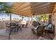 Covered patio with wicker furniture and fire pit at 3146 N 157Th Ln, Goodyear, AZ 85395