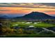 Scenic aerial view of a golf course community with desert landscape and sunset at 37200 N Cave Creek Rd # 1119, Scottsdale, AZ 85262