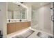 Contemporary bathroom with double sinks, a large mirror, and a walk-in shower at 37200 N Cave Creek Rd # 1119, Scottsdale, AZ 85262