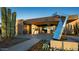 Modern building entrance with contemporary landscaping and art piece at 37200 N Cave Creek Rd # 1119, Scottsdale, AZ 85262